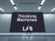 Thinking Machines Lab office sign with a professional entering the building, representing AI startup growth and talent acquisition from Meta.