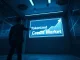 Tokenized credit market opportunity visualized with a financial analyst pointing at a $4 trillion holographic graph in a modern data center.
