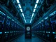 Interior of a large-scale cryptocurrency mining facility with rows of mining rigs and cooling systems.