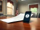 Official Senate letter questioning Trump memecoin event ethics on a desk with a smartphone.
