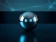 Worldcoin silver orb on a dark table with digital reflections