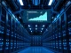 Interior view of a large AI data center with server racks and cooling systems, representing xAI's compute infrastructure for Grok.