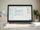 Slack workspace interface showing an @Claude interaction on a laptop in a modern office setting