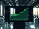 ARB/USD candlestick chart trending upward toward $6 on a professional trading display.
