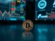 Bitcoin coin on reflective surface with blurred stock market screens in background