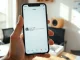Creator holding smartphone showing Facebook AI companion app interface