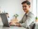 Candidate interviewing with an AI agent on a laptop in a modern home office setting