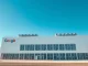 Exterior view of a large SpaceX data center facility under a clear sky
