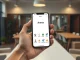 Smartphone displaying the Meta Arena prediction market app interface in a modern office setting
