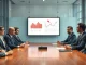 Corporate executives in a boardroom reviewing AI spending charts with red downward arrows