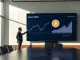 Corporate boardroom with Bitcoin price chart and executive signaling a purchase decision