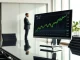 Computer monitor displaying an Ethereum price chart in a modern office boardroom.