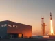 SpaceX headquarters with Falcon 9 rocket at sunset in Hawthorne, California