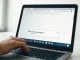 Close-up of a laptop screen showing a Google Docs document with a 'Write with Gemini' AI pop-up bar at the bottom.