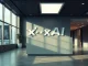 Empty corporate lobby with blurred xAI logo, illustrating the lawsuit against the AI company.