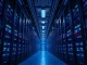 Interior of a modern data center with rows of server racks illuminated by blue and amber lighting