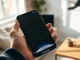 iPhone 17 Pro displaying the iOS 27 Siri AI interface in a bright living room