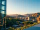 Gelephu Mindfulness City skyline with digital Bitcoin symbol integrated into architecture at sunset.