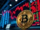 Bitcoin coin in foreground with red trading screens in background indicating ETF outflows