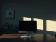 Empty office desk with a powered-down monitor and an Ethereum logo on the wall, representing the disbanding of the Ethereum Protocol Support Team.
