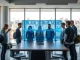 Team of tech professionals collaborating in a modern Paris office with a digital screen showing voice AI data