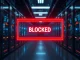 Digital barrier blocking AI crawling bots with red warning symbol in a data center setting