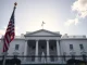 White House exterior on a sunny day, symbolizing presidential authority and the ongoing debate over Trump's crypto earnings.