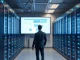 Developer reviewing AI application architecture on a monitor inside a modern enterprise data center