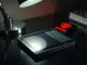 Hardware wallet on a dark surface with a red alert glow, symbolizing the Coldcard exploit.