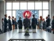 Business professionals reviewing AI network graphics on a large screen in a modern conference room