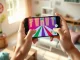 Hands holding a smartphone displaying a colorful interactive mini-game created with Meta's Pocket app.