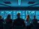 Security professionals monitoring AI threat dashboards in a modern operations center.
