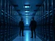 Secure data center corridor with server racks and a security guard, representing OpenAI's new monitoring safeguards