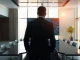 Executive in a modern office viewing a screen with code and AI graphics, representing the reported SpaceX-Cognition acquisition talks.