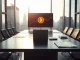 Corporate boardroom with Bitcoin chart on screen, symbolizing Strategy's treasury management