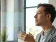 Person using Wispr AI dictation device in a modern office setting