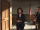Young woman with lawyer in courthouse hallway, representing a plaintiff in an AI abuse lawsuit