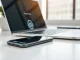 Smartphone and laptop on a desk with an AI assistant email interface